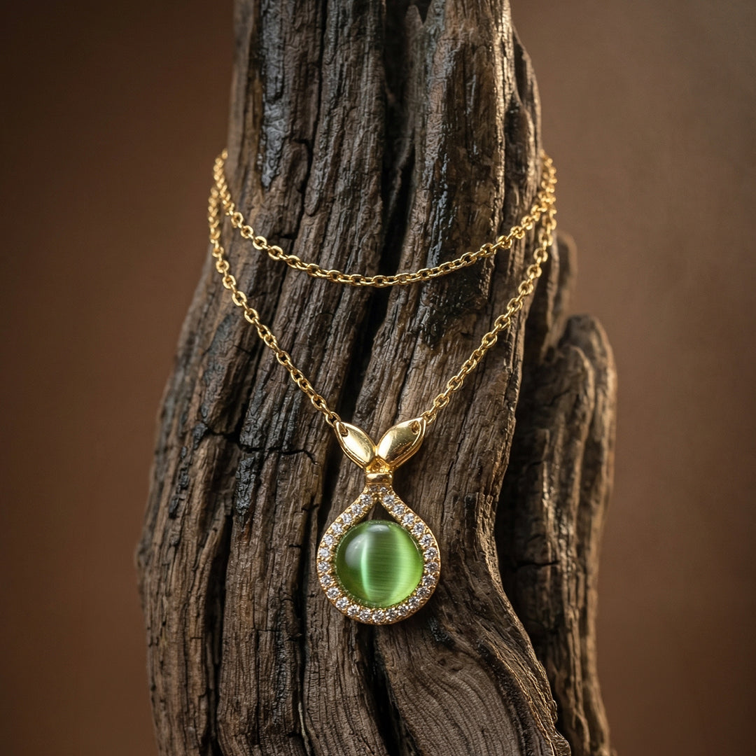 Gold necklace with a green gemstone  mermaid pendant on a wooden surface